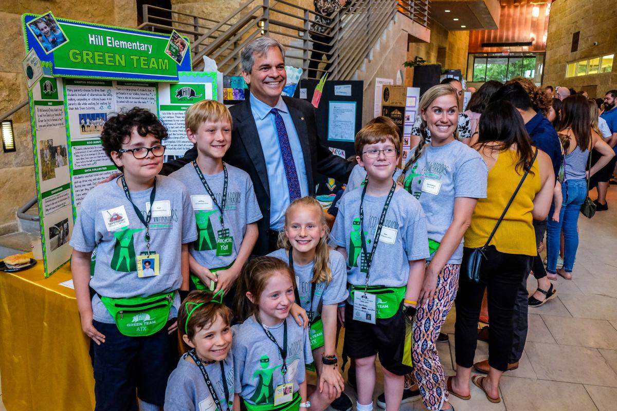 Mayor Steve Adler posing with students at the Student Innovation Showcase